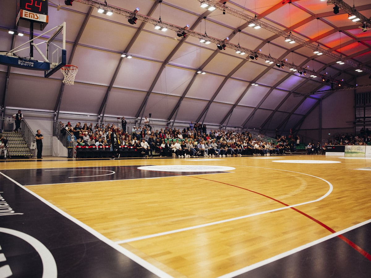 The inside of a basketball gym with players on the court