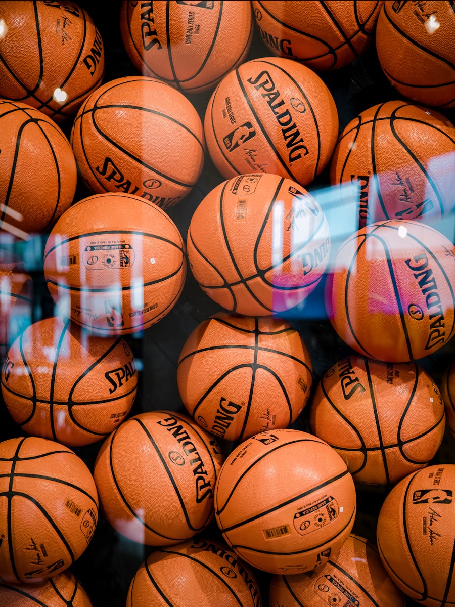 A rack of worn basketballs waiting at the side of a court